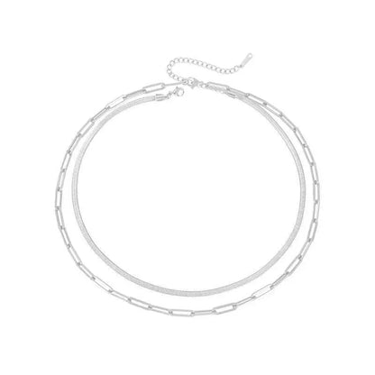 Silver two-layer chain necklace combining paperclip and snake link designs paired with 14k gold chain necklace Silver