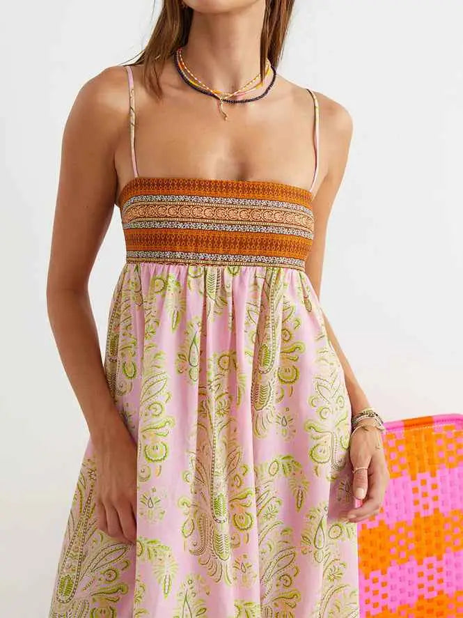 Pink and green paisley printed large swing dress with textured orange band at the waist ideal for summer wear