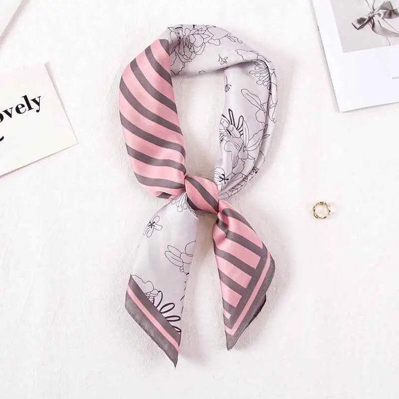 A high-end 90cm floral silk feel scarf in delicate pink and gray stripes tied in an elegant knot Striped Flower Pink Color