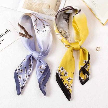 Two high-end 90cm floral silk scarves in lavender with white florals and vibrant yellow with black accents from trend den