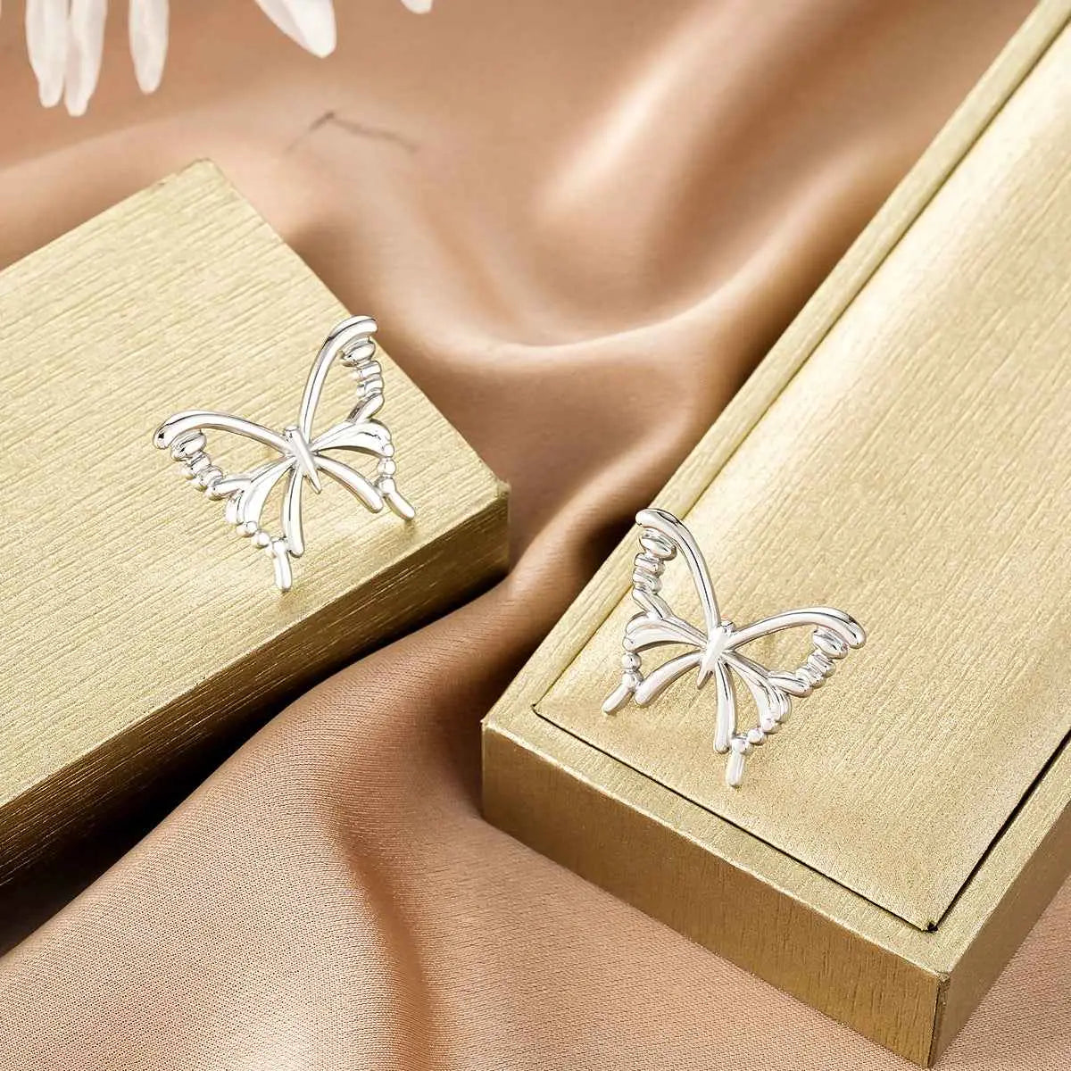 Silver butterfly-shaped stud earrings with openwork wings and polished finish from ins style gold fashion earring collection affordable luxury Style 15