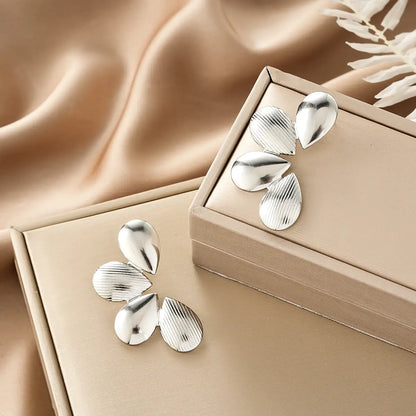 Silver teardrop earrings with brushed finish and vertical grooves in beige boxes from ins style gold fashion earring collection affordable luxury Style 27