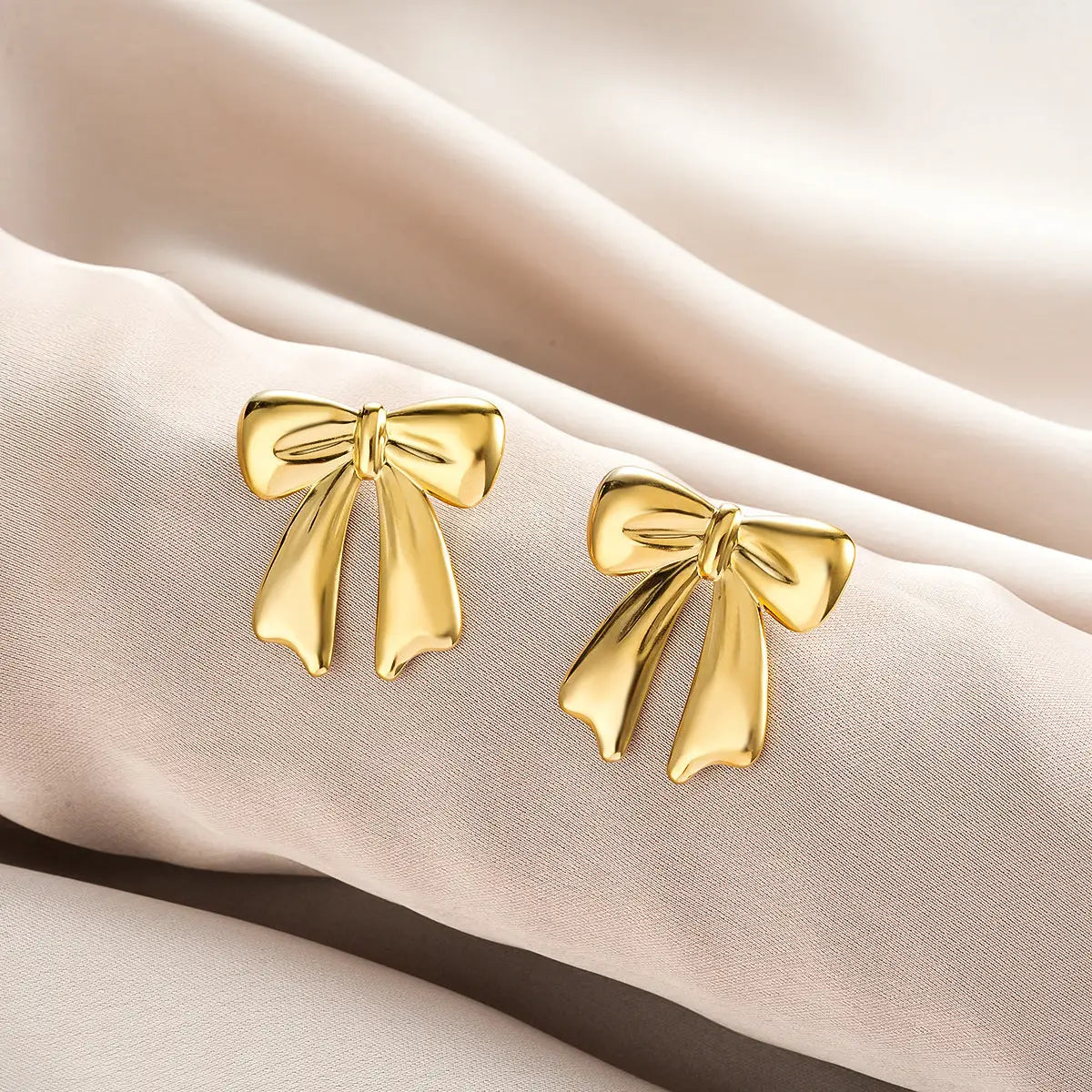 Golden bow-shaped stud earrings with polished metallic finish from ins style affordable luxury gold fashion earring collection Style 35