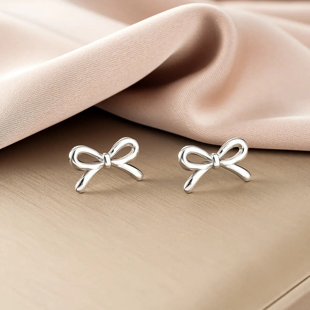 Ins style silver bow-shaped stud earrings with polished finish from gold fashion earring collection for affordable luxury Style 37