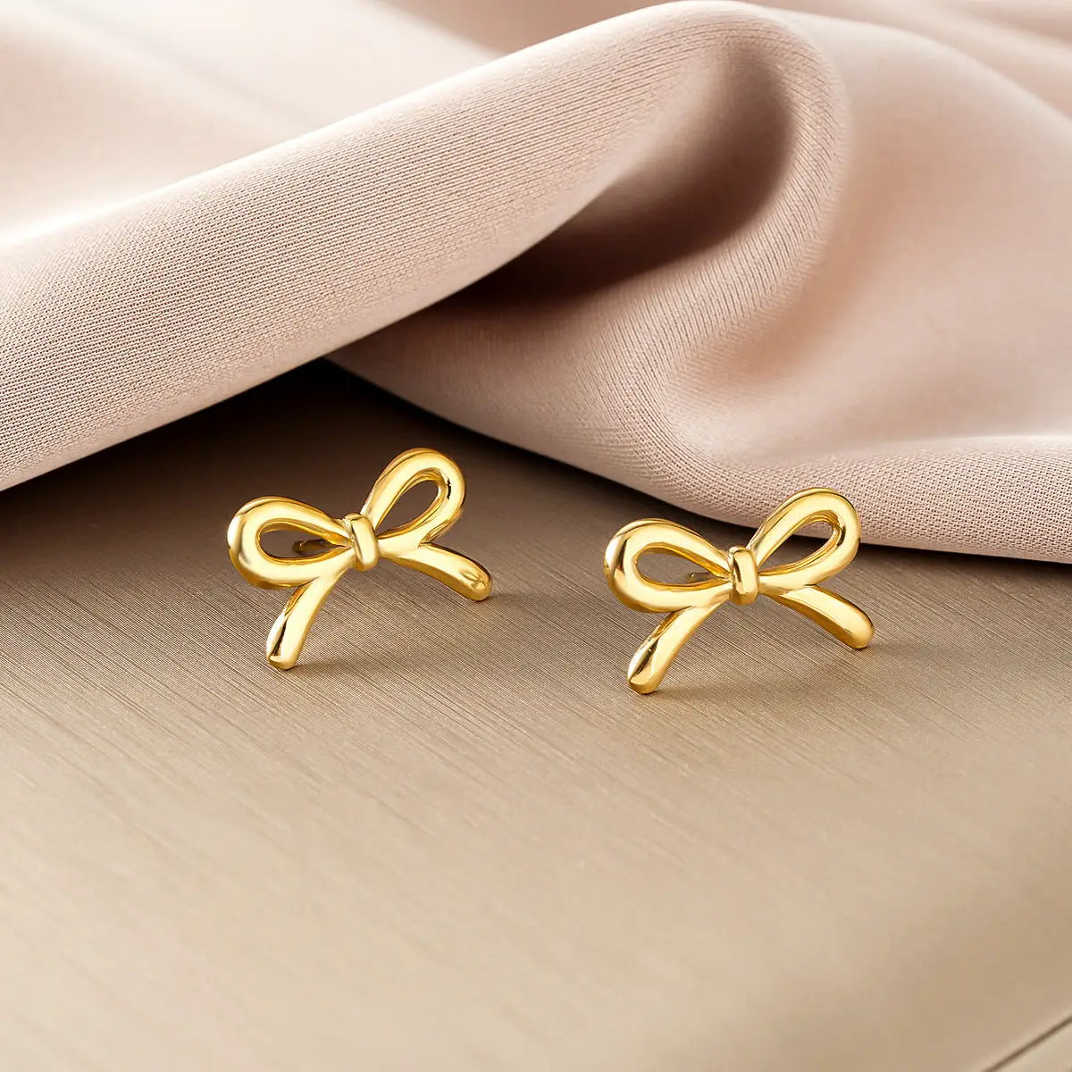 Golden bow-shaped stud earrings from ins style gold fashion earring collection with polished metallic finish for affordable luxury Style 43
