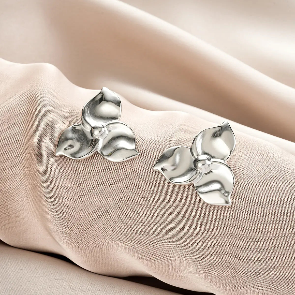 Silver flower-shaped stud earrings with polished metallic finish from ins style gold fashion earring collection affordable luxury Style 57