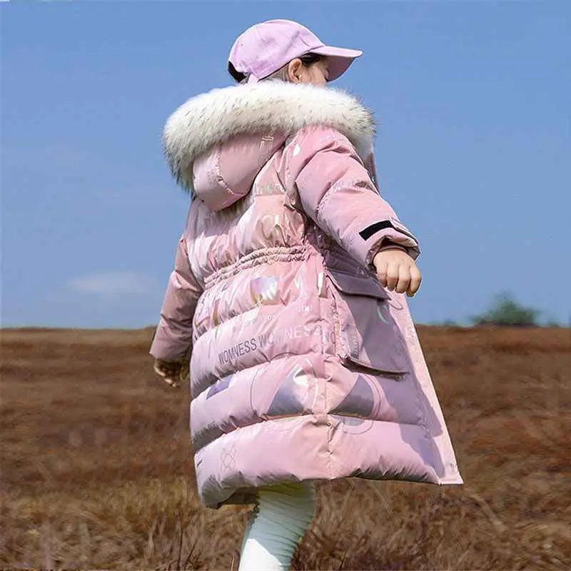 Kids long pink quilted winter coat with white fur-lined hood and iridescent patterns from trend den Pink