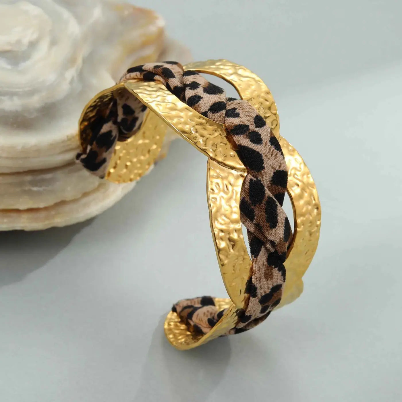 Gold-toned hammered metal cuff bracelet with braided leopard ribbon geometric fabric band for stylish wear