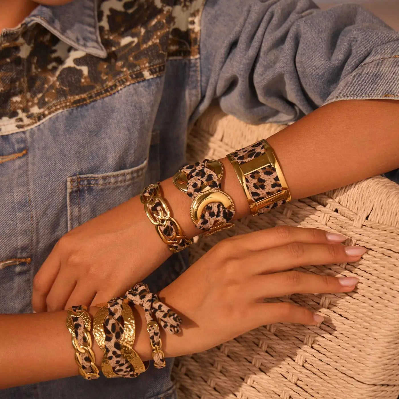 Gold-toned leopard ribbon geometric leather bracelets with chunky chain and buckle details in a bangle style
