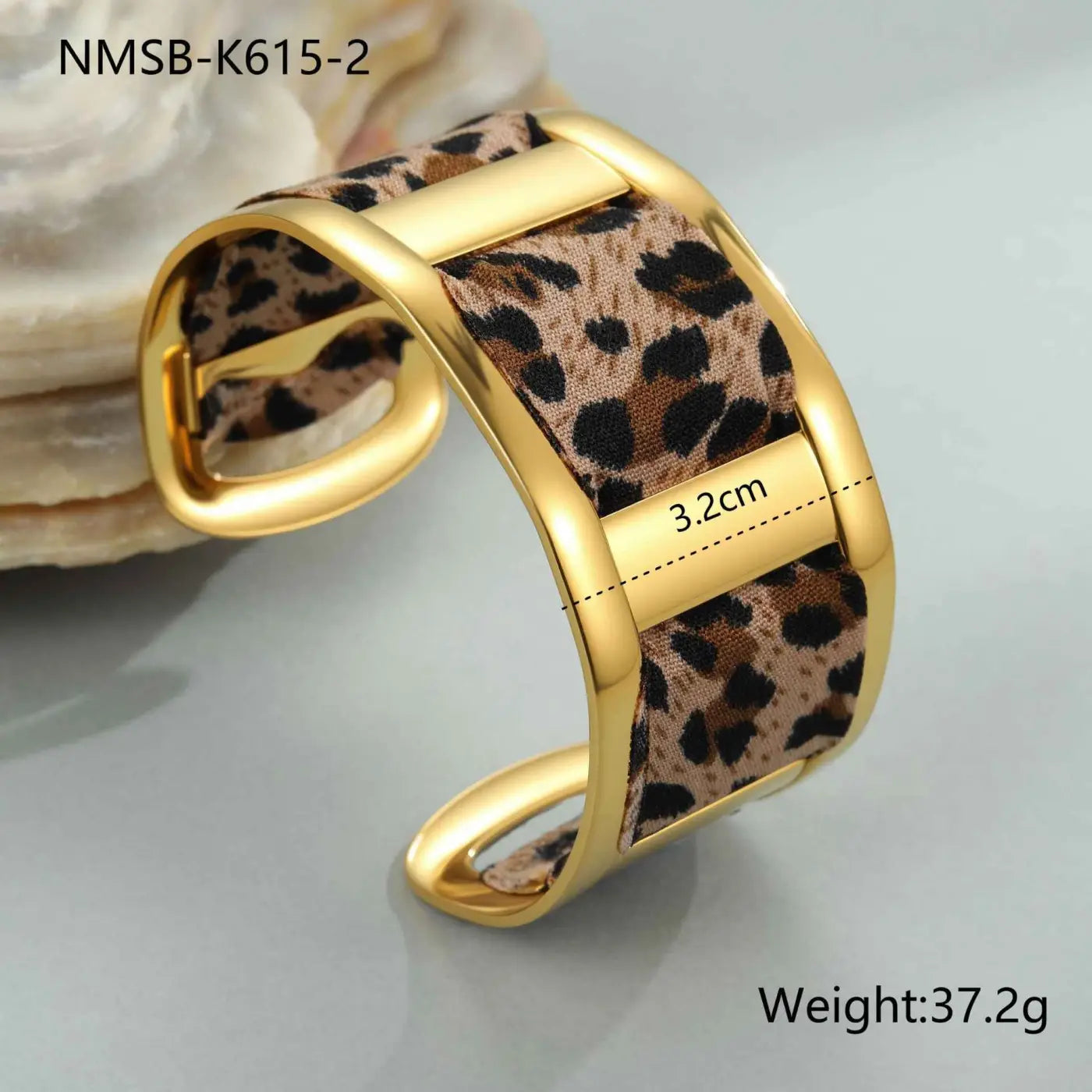 Gold-toned cuff bracelet with leopard ribbon geometric fabric band and metallic clasp in a stylish bangle design NMSBK6152