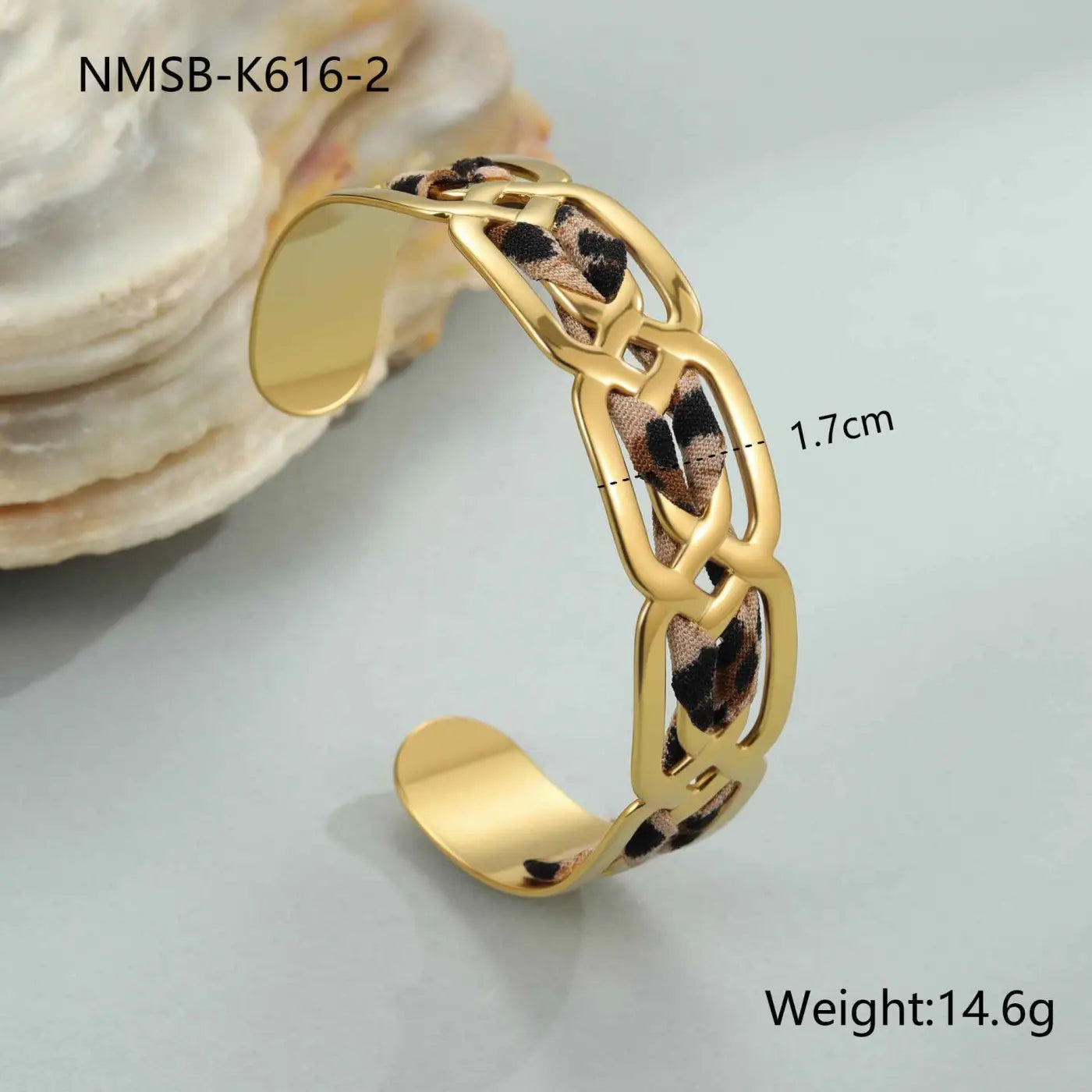 Gold-toned chain cuff bracelet with leopard ribbon fabric woven through links in leopard ribbon geometric bangle style NMSBK6162