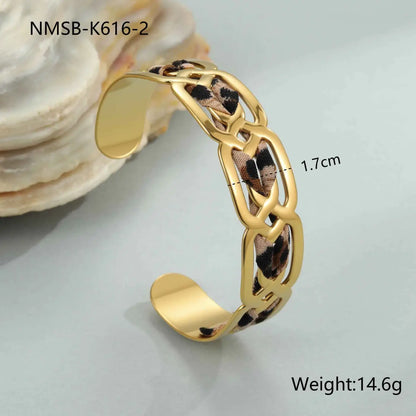 Gold-toned chain cuff bracelet with leopard ribbon fabric woven through links in leopard ribbon geometric bangle style NMSBK6162