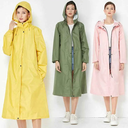 Three women model vibrant yellow olive green and pink lightweight fashion trench raincoats with hoods and waterproof material