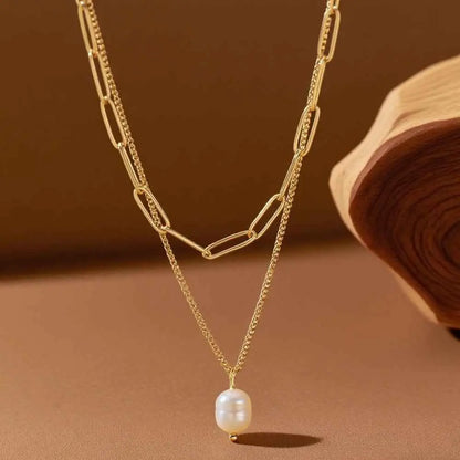 Lumina layered gold necklace with paperclip links and a single white pearl pendant in a delicate layered gold chain design Gold