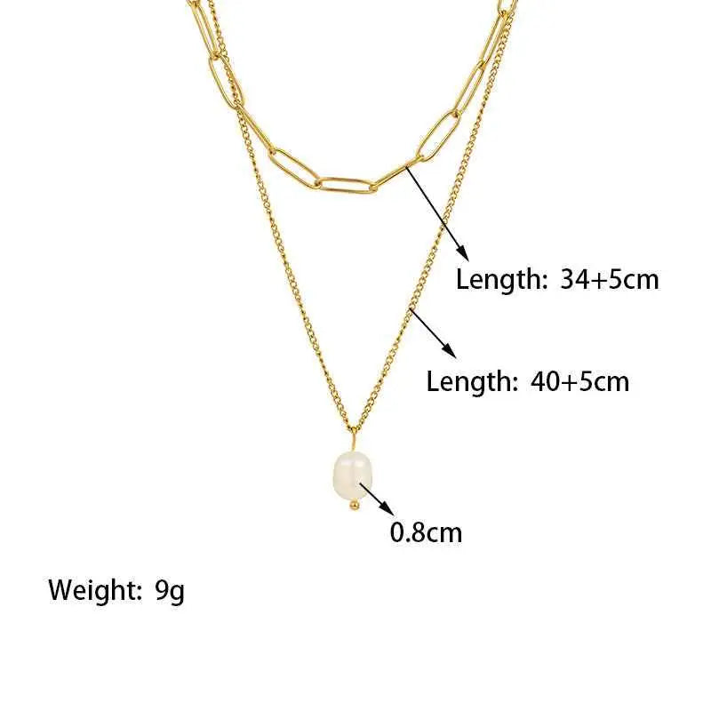 Gold-toned lumina layered necklace with delicate chain and oval-shaped pearl pendant featuring layered gold chain design