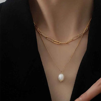 Lumina layered gold necklace with a chunky paperclip chain and fine chain featuring a single freshwater pearl pendant