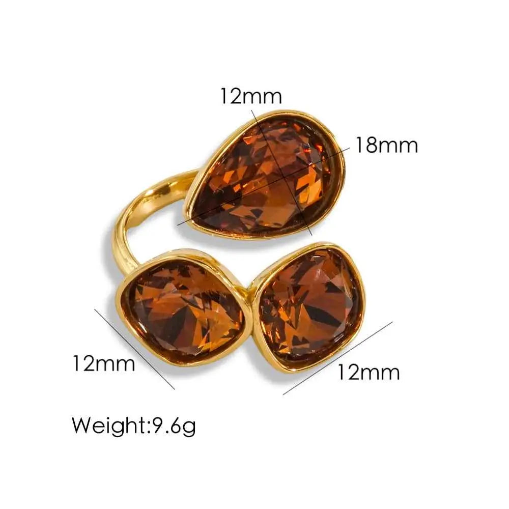 Gold-toned stainless steel zircon ring with three faceted amber stones in teardrop and oval design from trend den Caramel Color