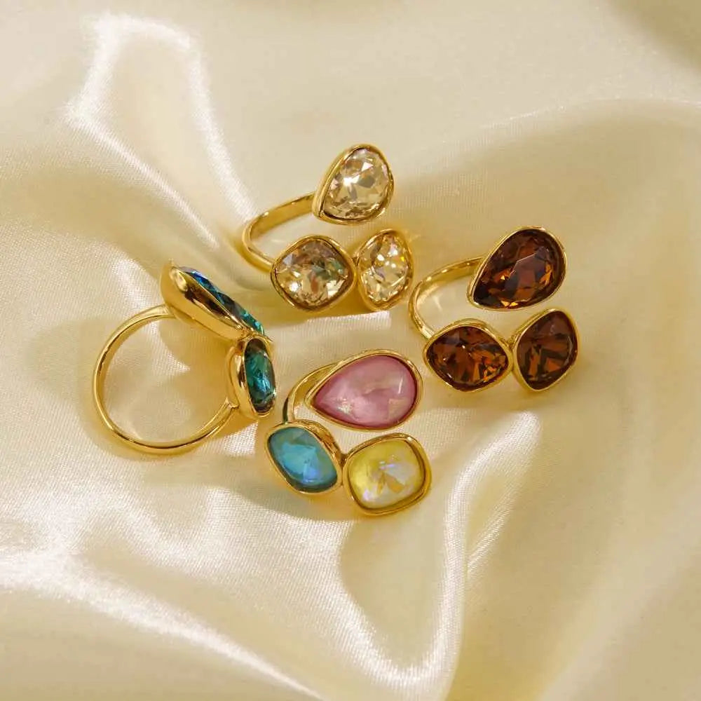 Luxury gold-toned stainless steel zircon ring collection with colorful faceted teardrop and square gemstones by trend den