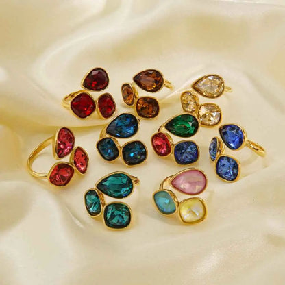 Luxury multi-stone zircon ring with vibrant red blue green teardrop gemstones in gold-toned stainless steel by trend den