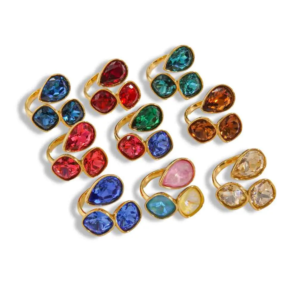 Luxury multi-stone zircon ring collection with stainless steel gold-toned bands and colorful teardrop-shaped crystals