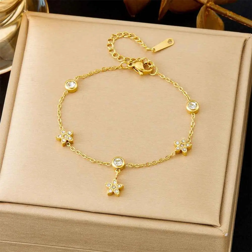 Gold-toned titanium steel star-themed fashion bracelet with clear crystal accents from trend den collection 5168 Snowflake Three Diamonds
