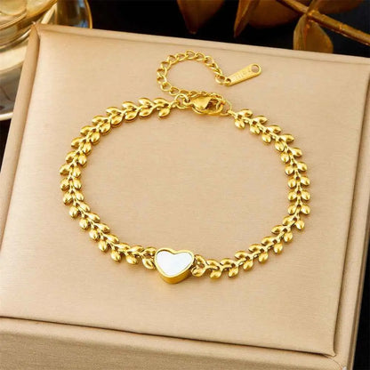 Gold-toned titanium steel fashion bracelet from trend den featuring leaf patterns and a central white heart charm 5177 Wheat White Love