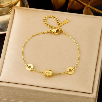 Gold-toned titanium steel fashion bracelet featuring a delicate chain with three charms from trend den collection 5189 Thin Waist