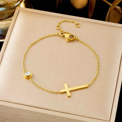 Gold-toned titanium steel cross bracelet with delicate chain and crystal accent from trend den fashion bracelet collection 5203 Cross