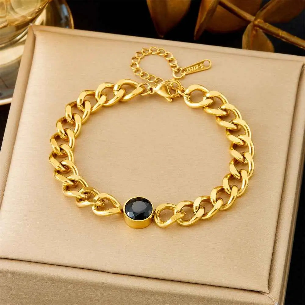 Gold-toned titanium steel curb chain fashion bracelet from trend den with central black gemstone bezel design 5208 Black Diamond Cuba