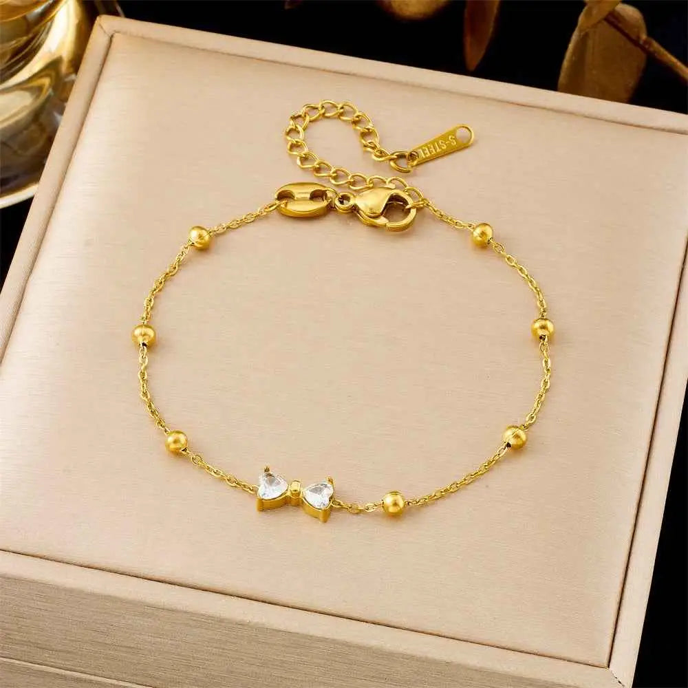 Gold-colored titanium steel fashion bracelet featuring a delicate chain with spherical beads and a crystal bow charm from trend den 5233 Bow Ball Bead Chain