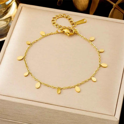 A delicate gold-toned titanium steel anklet with flat oval charms from the luxury fashion bracelet collection trend den 5250 Water Droplets