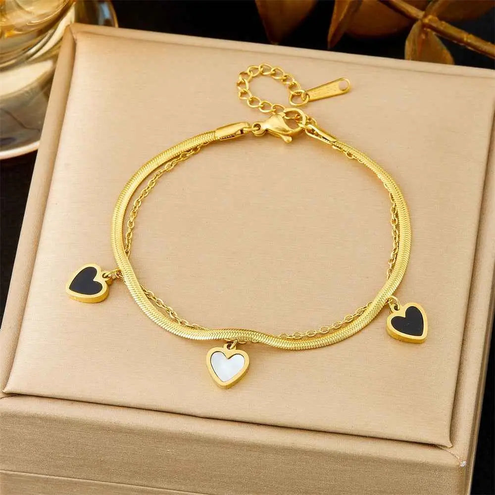Gold-toned titanium steel snake chain fashion bracelet with three heart-shaped charms from trend den collection 5252 Black And White Heart