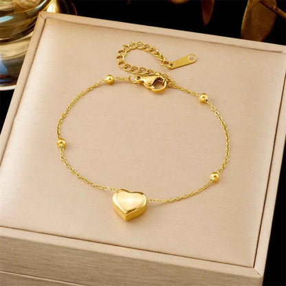 Gold heart charm bracelet with small beads and secure clasp in luxury titanium steel fashion bracelet collection by trend den 5255 Round Beads Love