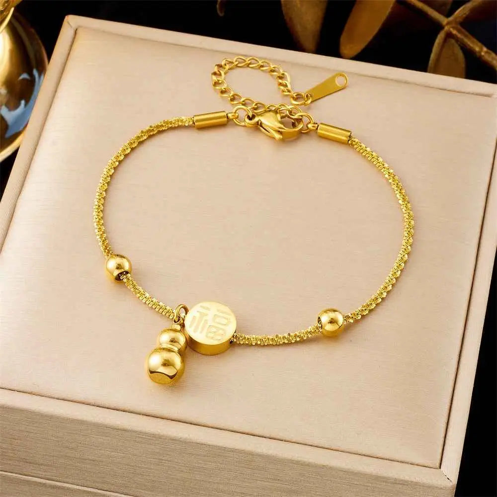Golden titanium steel fashion bracelet with textured chain, small beads, and engraved chinese character charm from trend den 5257 Twist Fu Character