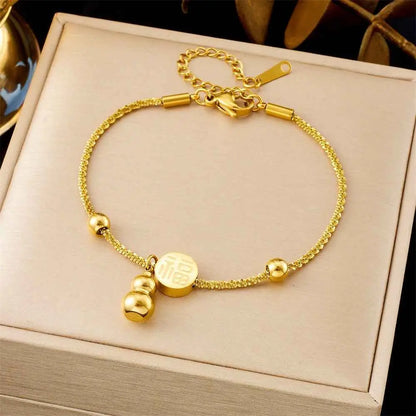 Golden titanium steel fashion bracelet with textured chain, small beads, and engraved chinese character charm from trend den 5257 Twist Fu Character