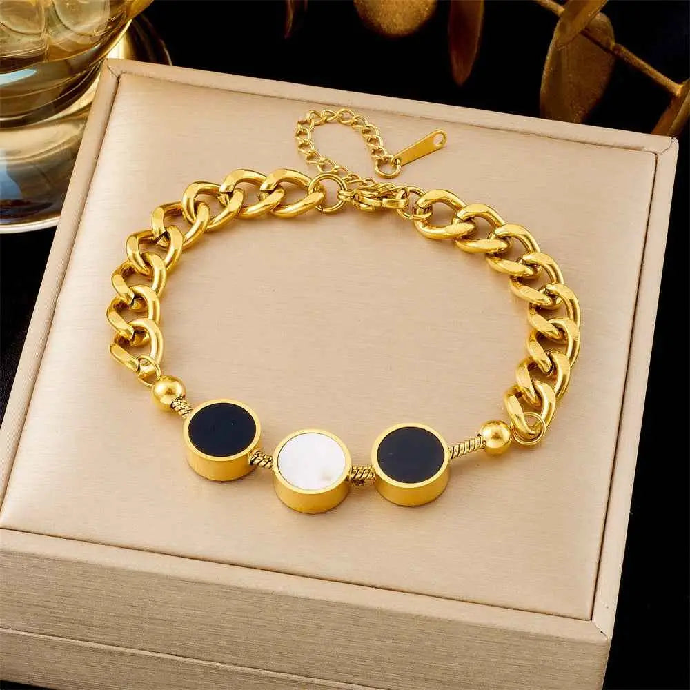 Gold chain bracelet with black and white round beads on a beige jewelry box. 5264 Black And White Round
