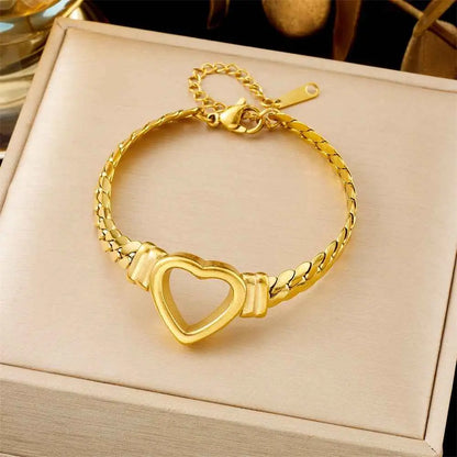 Trend Dens Gold bracelet with a heart-shaped clasp on a beige box 5266 Hollow Heart