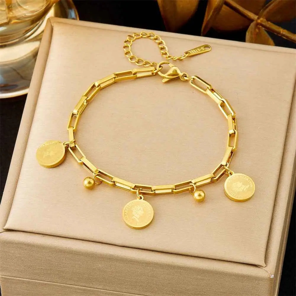 Gold bracelet with circular charms on a beige jewelry box 5291 Queen