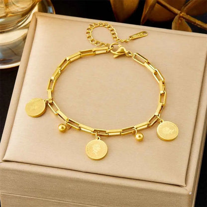 Gold bracelet with circular charms on a beige jewelry box 5291 Queen