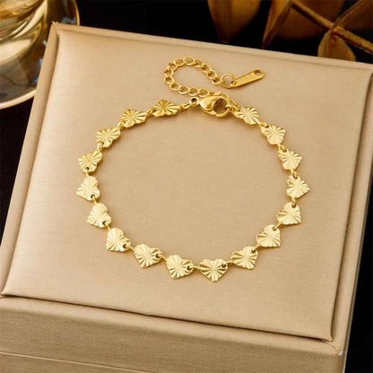 Gold bracelet with heart-shaped links on a beige box 5345 Laser Pattern Love