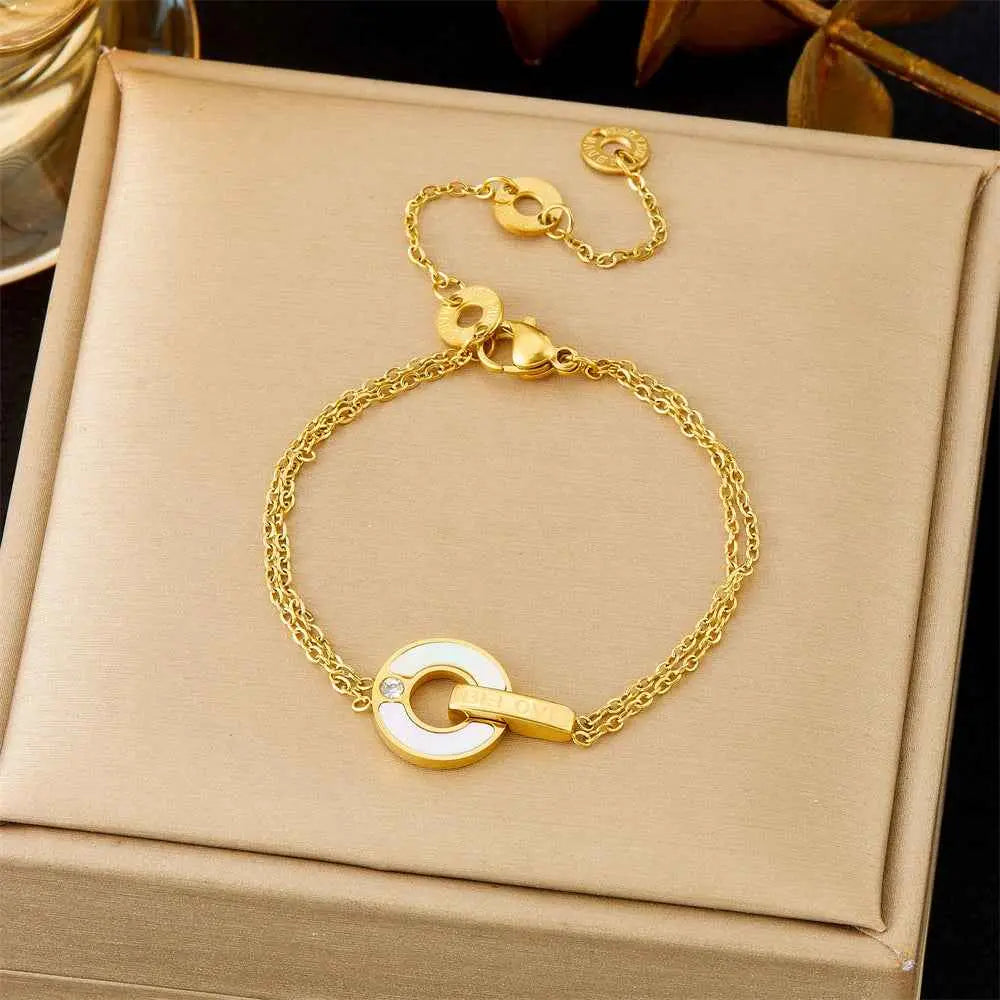 Gold bracelet on a beige jewelry box with a dark background 5347love White Shell Round