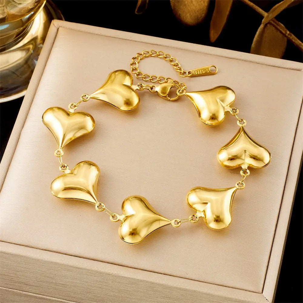 Gold heart-shaped bracelet on a beige jewelry box 5349 Full Love Necklace
