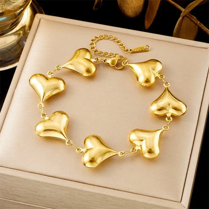 Gold heart-shaped bracelet on a beige jewelry box 5349 Full Love Necklace