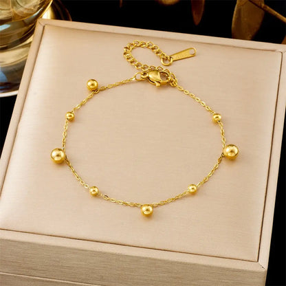 Trend Dens round ball charms Gold bracelet on a beige jewelry box with a blurred background 5352 Size Beads