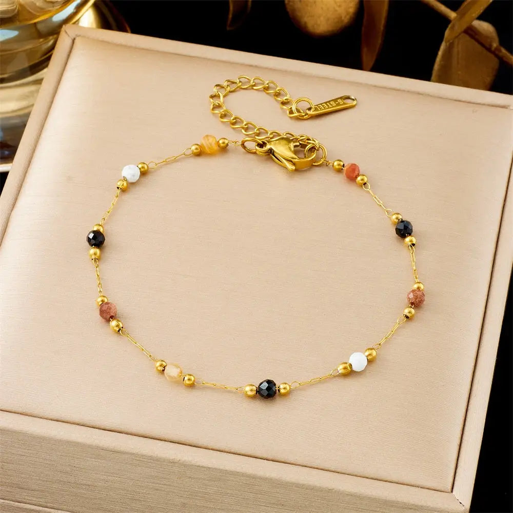 Gold bracelet with colored beads on a beige jewelry box 5367 Colorful Beads String