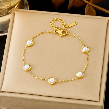 Gold bracelet with pearl-like beads on a beige jewelry box 5370 White Bead Necklace