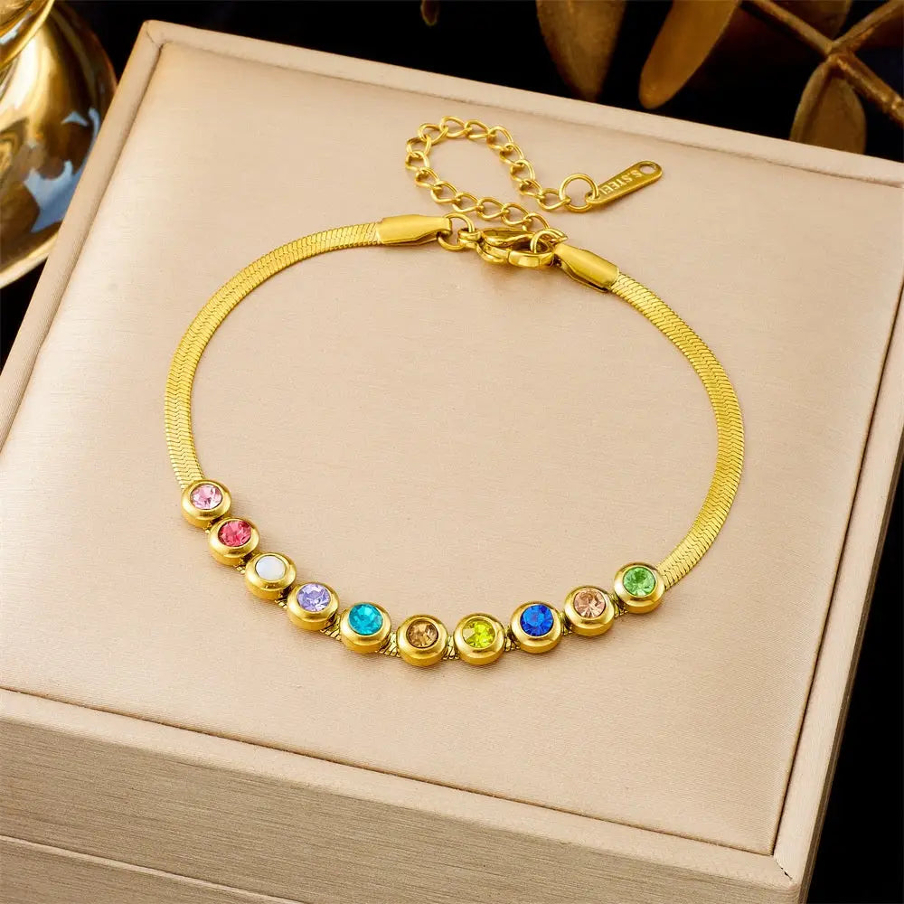 Gold bracelet with colorful gemstones on a beige jewelry box 564 Colorful Crystals