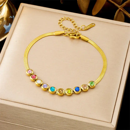 Gold bracelet with colorful gemstones on a beige jewelry box 564 Colorful Crystals
