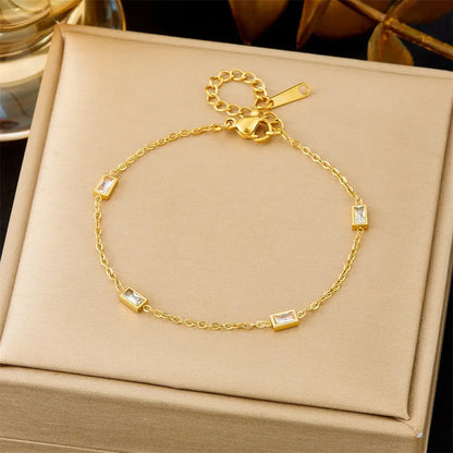 Gold bracelet with white gemstones on a beige box 566 Small Square Diamond