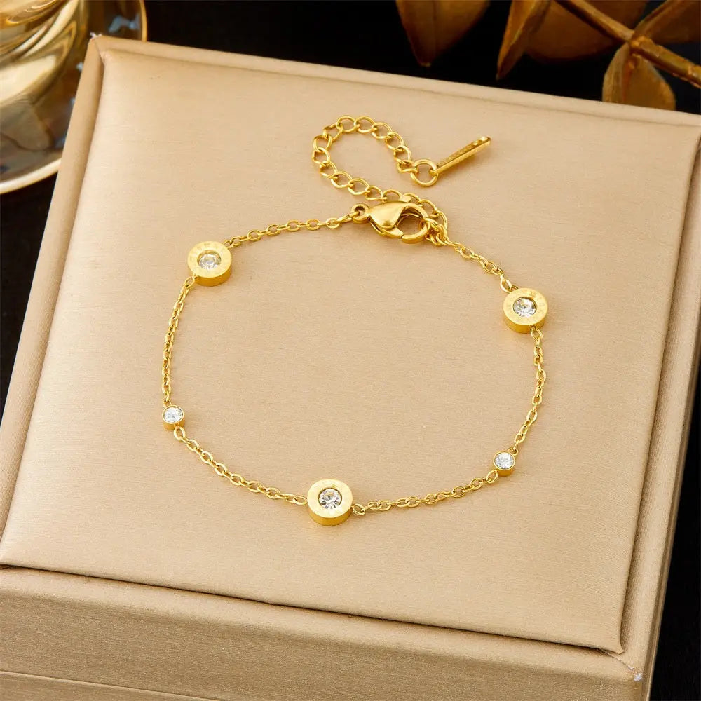 Trend Dens Gold bracelet with white gemstones on a beige jewelry box 570 Three Rome